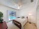 Bright bedroom with a ceiling fan, a sliding door to the pool, and a neutral decor scheme at 1280 Thornton Ct, Spring Hill, FL 34608