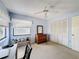 Comfortable bedroom with a bright window, a ceiling fan, carpeted floors, and a spacious closet at 1280 Thornton Ct, Spring Hill, FL 34608