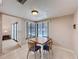 Bright dining area adjacent to kitchen featuring a window, tile flooring, and view of the living room at 1280 Thornton Ct, Spring Hill, FL 34608