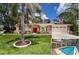 Charming one-story home boasting a bright red front door, mature landscaping, and a two-car garage at 1280 Thornton Ct, Spring Hill, FL 34608