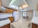 Eat-in kitchen with light wood cabinets, white appliances, and a unique tray ceiling with fan at 1280 Thornton Ct, Spring Hill, FL 34608
