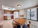 Bright kitchen features a ceiling fan, white appliances, and an adjacent dining area with outdoor access at 1280 Thornton Ct, Spring Hill, FL 34608
