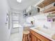 Efficient laundry room with ample storage shelving, a utility sink, and a washer/dryer, ideal for organization at 1280 Thornton Ct, Spring Hill, FL 34608