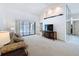 Spacious living room with a large sliding glass door overlooking the pool area, offering ample natural light at 1280 Thornton Ct, Spring Hill, FL 34608