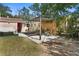 Outdoor living area with a pergola, seating, hammock, and manicured landscaping for relaxation and entertainment at 1309 45Th S St, St Petersburg, FL 33711