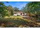 Spacious backyard featuring a pergola, hammock, and lush landscaping, ideal for outdoor living and recreation at 1309 45Th S St, St Petersburg, FL 33711