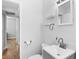 Bright bathroom with white vanity, tile floors, and a gray cabinet at 1309 45Th S St, St Petersburg, FL 33711