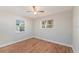 Bright bedroom featuring wood-look floors, two windows, and white trim at 1309 45Th S St, St Petersburg, FL 33711
