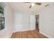 Bright bedroom featuring wood-look floors, ceiling fan, and white doors and trim at 1309 45Th S St, St Petersburg, FL 33711