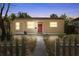 Charming single story home with a red front door and a well-manicured lawn, framed by a white picket fence at 1309 45Th S St, St Petersburg, FL 33711