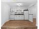 Bright kitchen with white cabinetry, modern appliances, and new flooring, creating a clean and functional space at 1309 45Th S St, St Petersburg, FL 33711
