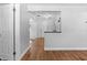 Living room with view of kitchen, and continuous wood-look flooring at 1309 45Th S St, St Petersburg, FL 33711