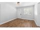 Bright living room with wood-look floors and a modern light fixture at 1309 45Th S St, St Petersburg, FL 33711