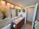 Bathroom features stylish vanity, updated lighting, and bathtub with shower at 1412 Linstock Dr, Holiday, FL 34690