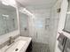 Updated bathroom with large glass enclosed shower with stone base and modern fixtures at 1412 Linstock Dr, Holiday, FL 34690