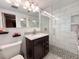 Beautiful bathroom with a modern shower with stone base, sleek vanity, and contemporary lighting at 1412 Linstock Dr, Holiday, FL 34690
