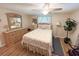 Bright bedroom boasts wood-look floors, ceiling fan, and neutral paint scheme at 1412 Linstock Dr, Holiday, FL 34690