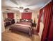 Bedroom features ceiling fan, hardwood floors, and closet for storage at 1412 Linstock Dr, Holiday, FL 34690