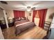 Bedroom features ceiling fan, hardwood floors, and closet for storage at 1412 Linstock Dr, Holiday, FL 34690
