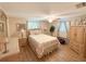 Charming bedroom features wood-look floors, natural light, and traditional furniture at 1412 Linstock Dr, Holiday, FL 34690