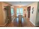 Light-filled dining room with wood floors, elegant china cabinet, and sliding glass doors at 1412 Linstock Dr, Holiday, FL 34690