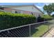 Side view of home with manicured hedges and partial fencing at 1412 Linstock Dr, Holiday, FL 34690