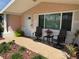 Charming front porch with chairs and decor, enhanced by beautiful landscaping and a welcoming entrance at 1412 Linstock Dr, Holiday, FL 34690