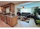 Open-concept kitchen with granite countertops seamlessly flows into the living room and dining spaces at 1412 Linstock Dr, Holiday, FL 34690