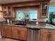Modern kitchen featuring granite countertops, stainless appliances and tile floor at 1412 Linstock Dr, Holiday, FL 34690