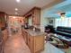 Charming kitchen with granite countertops and tile flooring connecting to the dining and living room areas at 1412 Linstock Dr, Holiday, FL 34690