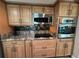 Updated kitchen showcases stainless appliances, granite countertops, and stylish backsplash at 1412 Linstock Dr, Holiday, FL 34690