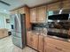 Beautiful kitchen with stainless steel refrigerator and granite countertops with tile floors at 1412 Linstock Dr, Holiday, FL 34690