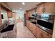 Modern kitchen featuring granite countertops, stainless appliances and tile floor at 1412 Linstock Dr, Holiday, FL 34690