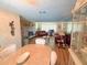 Open-concept living area with brick fireplace, tile flooring, and neutral color scheme at 1412 Linstock Dr, Holiday, FL 34690