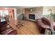 Large living room with hardwood flooring, brick fireplace, and a view to the dining area at 1412 Linstock Dr, Holiday, FL 34690