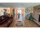 Open living space with fireplace, hardwood floors, and views to the dining area at 1412 Linstock Dr, Holiday, FL 34690
