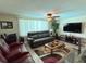 Living room with modern decor including a flat screen tv and ceiling fan at 1412 Linstock Dr, Holiday, FL 34690