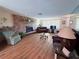 Spacious living room features a brick fireplace and wood laminate flooring at 1412 Linstock Dr, Holiday, FL 34690