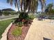 Outdoor patio area with table and chairs next to garden at 1412 Linstock Dr, Holiday, FL 34690