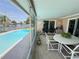 The screened-in patio offers views of the pool and canal, creating a serene outdoor living space at 1412 Linstock Dr, Holiday, FL 34690