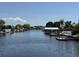 Scenic waterfront view featuring the canal and neighborhood boat docks under a partly cloudy blue sky at 1412 Linstock Dr, Holiday, FL 34690