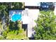 Aerial view of a home featuring a backyard pool, spacious patio with seating, and mature trees at 1540 Lime St, Clearwater, FL 33756