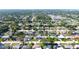 This aerial photo shows a residential neighborhood with many houses, roads, and lush trees throughout the area at 1540 Lime St, Clearwater, FL 33756