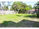 Spacious backyard with well-maintained lawn, surrounded by a wooden fence for privacy at 1540 Lime St, Clearwater, FL 33756