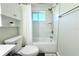 Bright bathroom featuring white tile, shower-tub combo and modern fixtures at 1540 Lime St, Clearwater, FL 33756