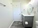 Bathroom featuring a gray vanity, toilet, and tile flooring at 1540 Lime St, Clearwater, FL 33756