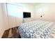 Bedroom with wood-look floors, queen size bed, dresser, and sliding closet door at 1540 Lime St, Clearwater, FL 33756