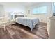 Bedroom with wood-look floors, queen size bed, and ample natural light at 1540 Lime St, Clearwater, FL 33756