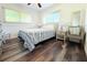 Bedroom featuring wood-look floors, queen size bed and two windows at 1540 Lime St, Clearwater, FL 33756