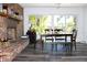 Inviting dining area featuring a brick fireplace, large windows, and hardwood flooring at 1540 Lime St, Clearwater, FL 33756